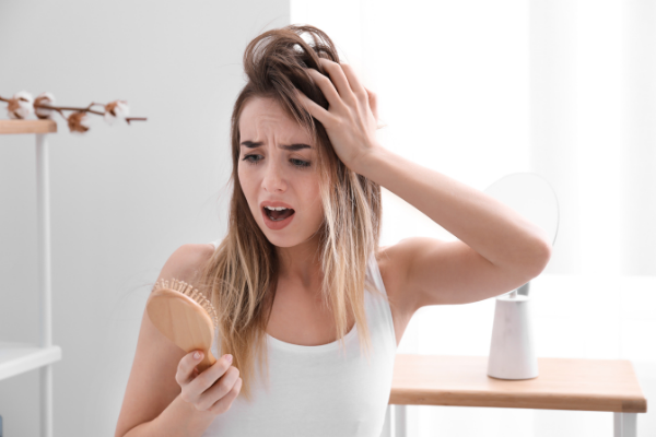 8 Postpartum Hair Loss Tips and Treatments | Hormonal changes after childbirth can cause many new moms to lose their hair. This is completely normal and usually nothing to worry about, but it can be alarming and upsetting all the same. If you want to know how to grow your hair, how to make your hair thicker, and how to cope with these hormonal changes, this post has everything you need - causes, symptoms, and hair care tips and hacks to reduce hair loss and make your hair look thicker.