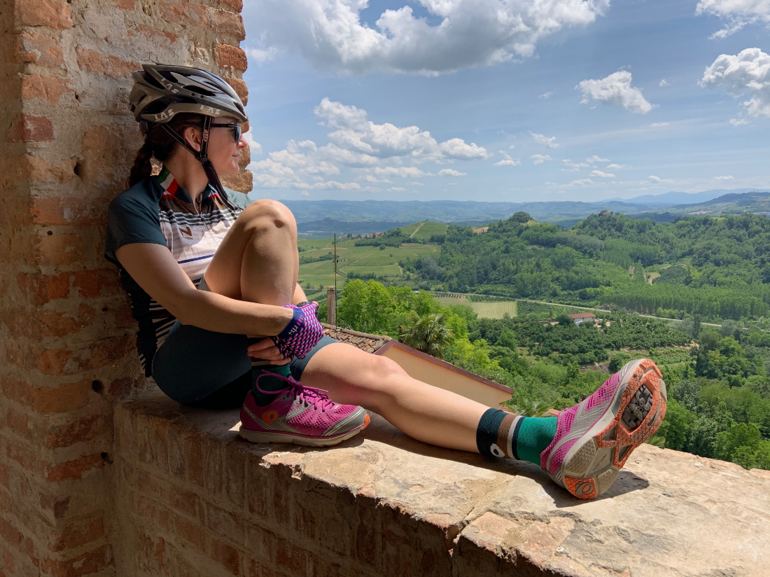 Heather Dowd of Tourissimo cycling tours in Italy overlooking the landscape in cycle gear