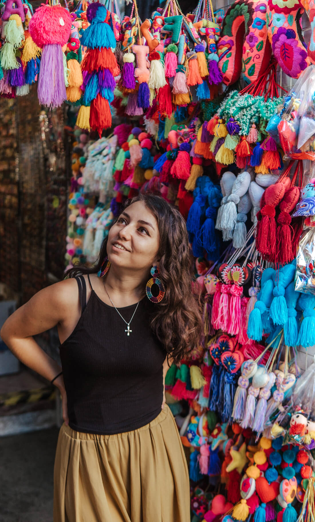 Stacey Valle standing in front of a colorful market vendor display