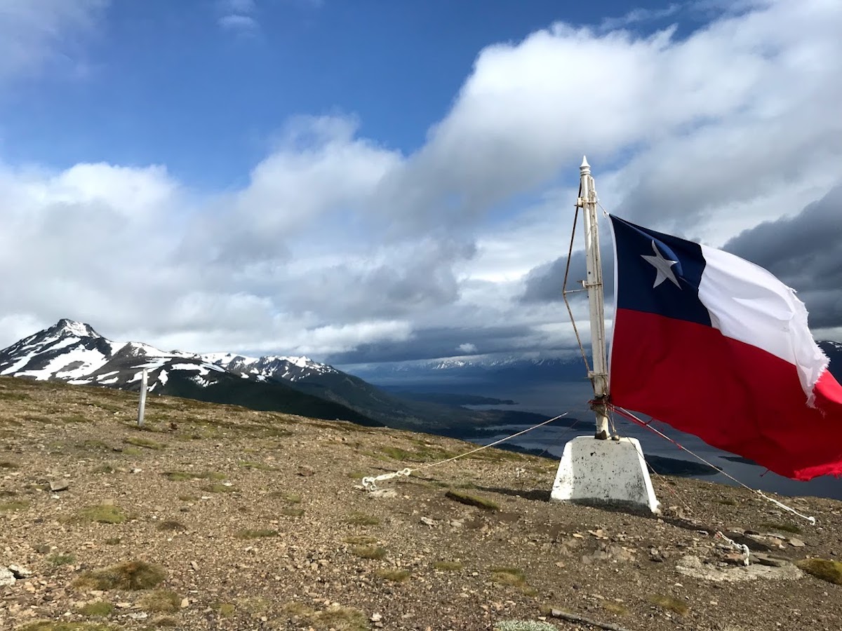The end of the world with a Chilean flag atop the Cerro Bandera in Puerto Williams, Chile