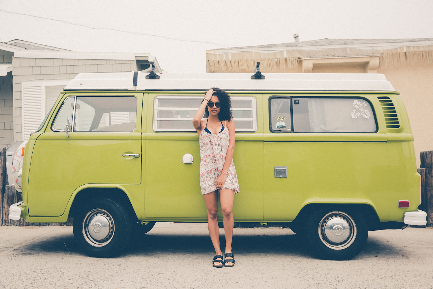 Woman standing in front of a VW van - a guide for solo travel for Black women