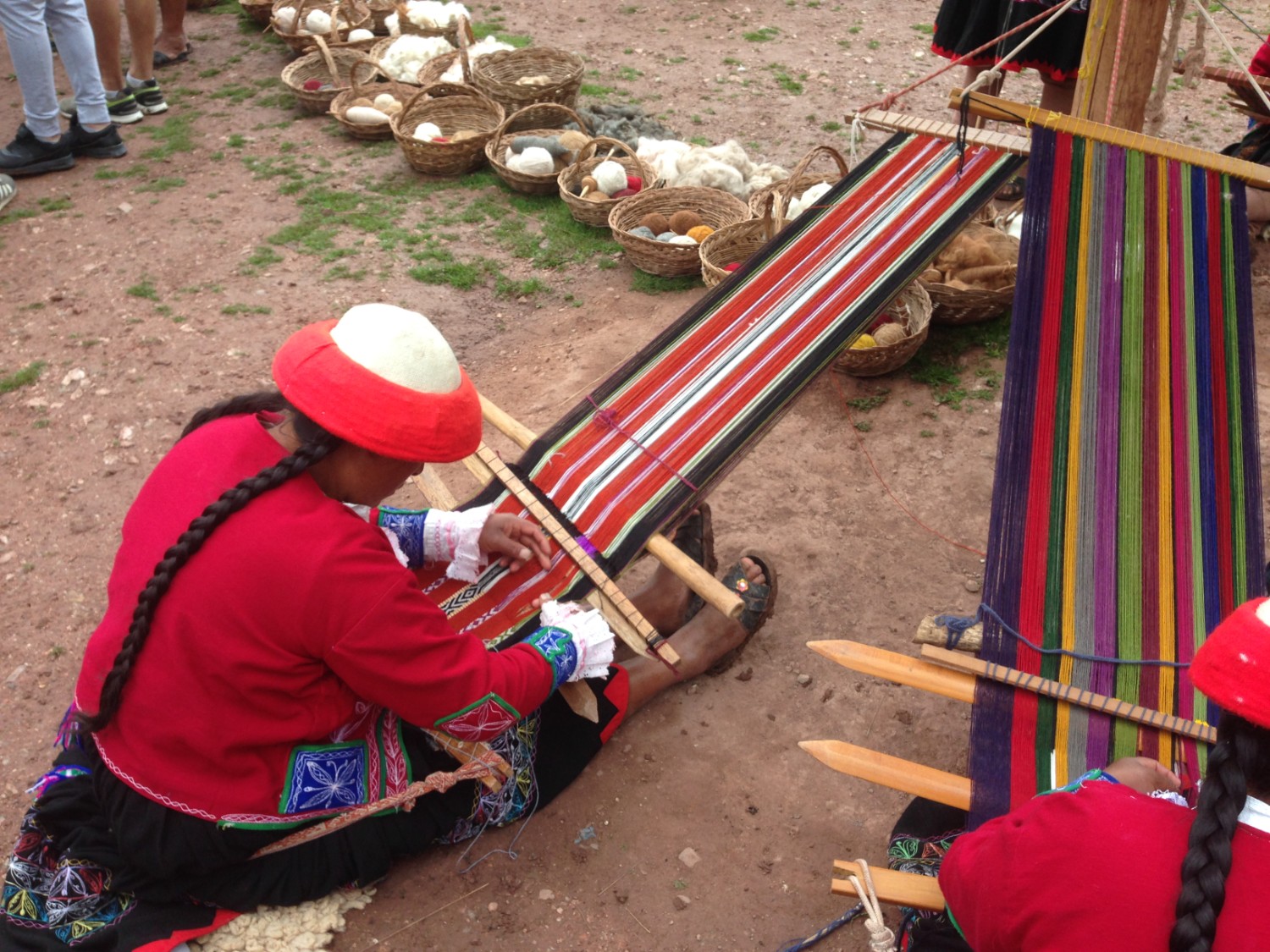 A woman in Ccaccaccollo Peru weaving in the traditional way