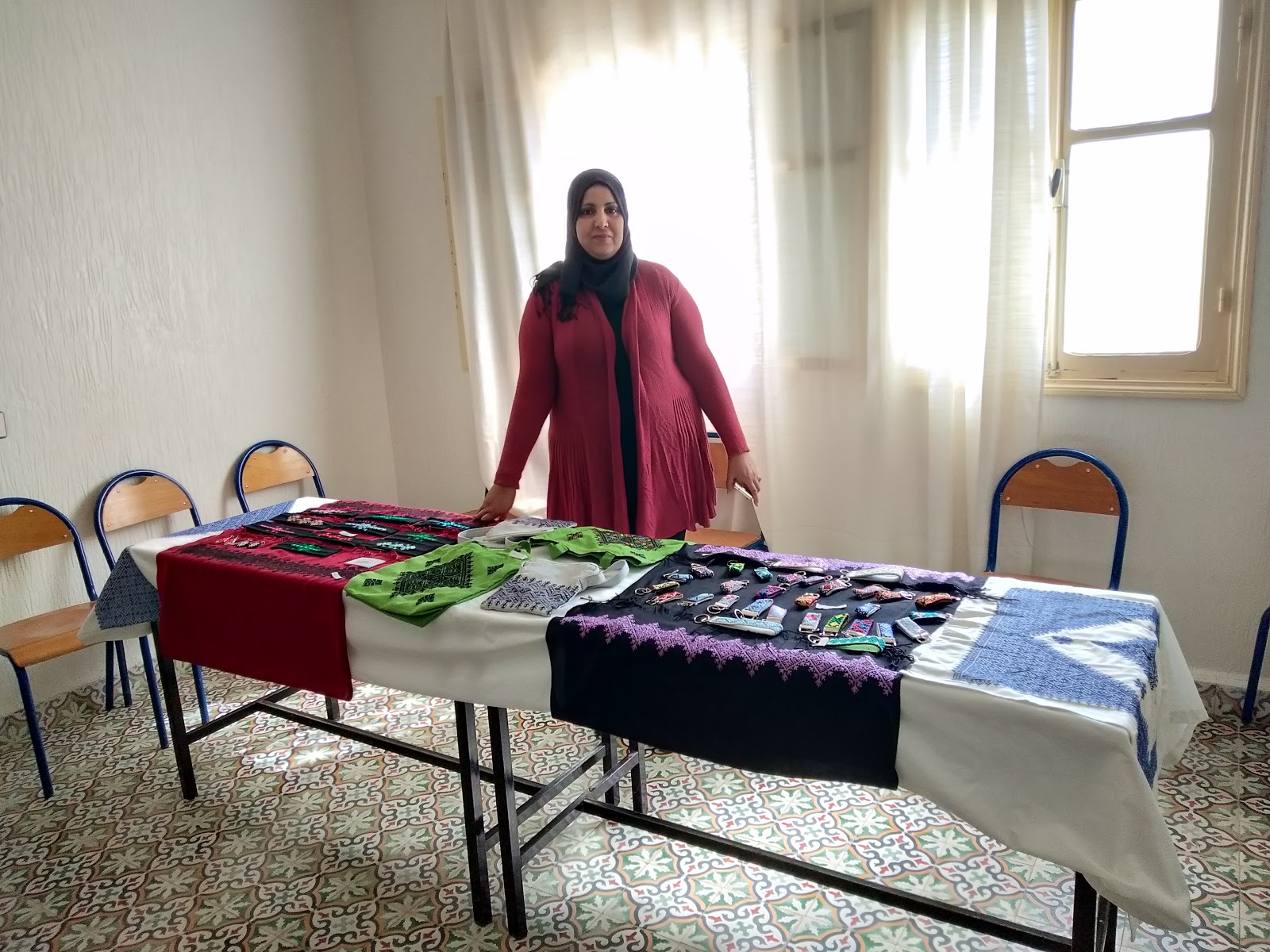 Woman showing the artisan crafts made at Nzala Women's Cooperative in Morocco