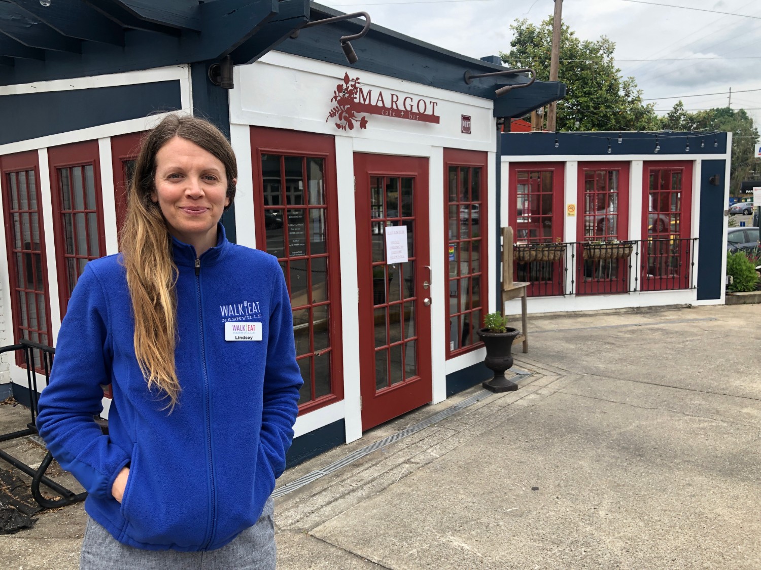 Lindsey Bathke, tour guide at Walk Eat Nashville, standing in front of Margot, one of her favorite places to eat in East Nashville