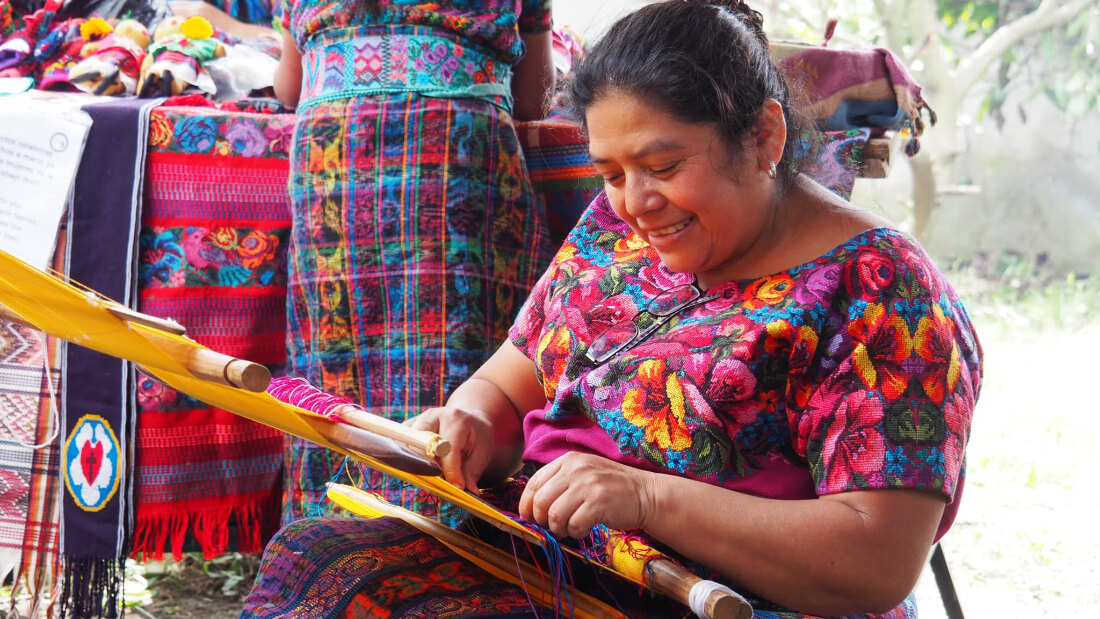 Woman weaving at the women’s artisan co-op called Casa Flor Ixcaco in Guatemala
