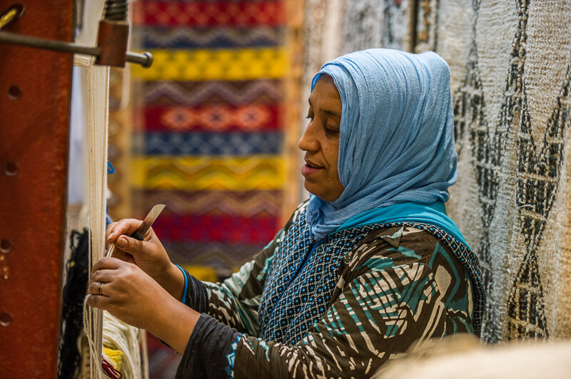 Woman weaving a rug in Morocco