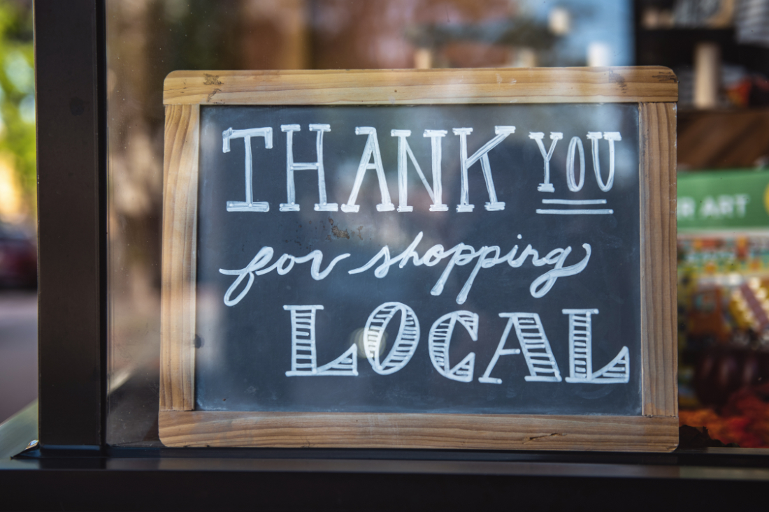 Chalkboard sign that says "Thank you for shopping local"