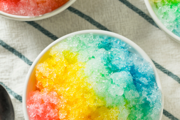 14 Homemade Snow Cone Syrup Recipes to Make with Your Kids | Nothing screams summer vacation like a snow cone, am I right?! If you want to know how to make snow cones at home without a snow cone maker, this post is for you! We've got step by step instructions, including budget friendly snow cone essentials to invest in. And, we've rounded up the best DIY snow cone syrup recipes, with a mix of options with and without Kool Aid, and lots of healthy ideas that are sugar free and delish!