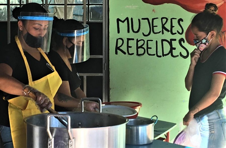 Kitchen volunteers at Proyecto Florecer in Medellin. Written on the wall in the background is "Mujeres Rebeldes"