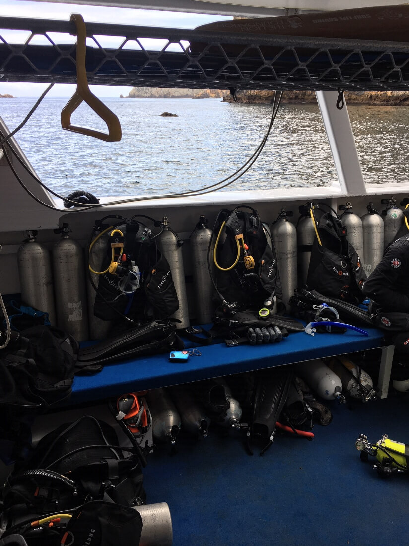 Scuba tanks and gear on a dive boat ready for use